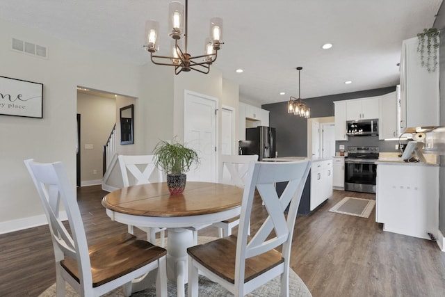 9559 Basil Rd NW, Baltimore, OH 43105 - dining area with a chandelier, dark wood finished floors, recessed lighting, baseboards, and stairway