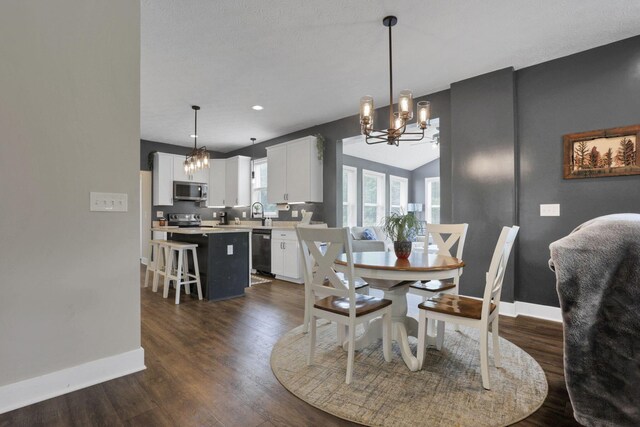 9559 Basil Rd NW, Baltimore, OH 43105 - dining room with a chandelier, baseboards, dark wood-type flooring, lofted ceiling, and recessed lighting