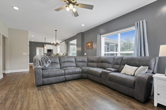 9559 Basil Rd NW, Baltimore, OH 43105 - living room featuring dark wood-style floors, a chandelier, a ceiling fan, baseboards, and recessed lighting
