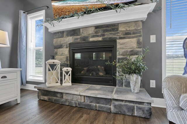 9559 Basil Rd NW, Baltimore, OH 43105 - detailed view of wood finished floors, baseboards, and a stone fireplace