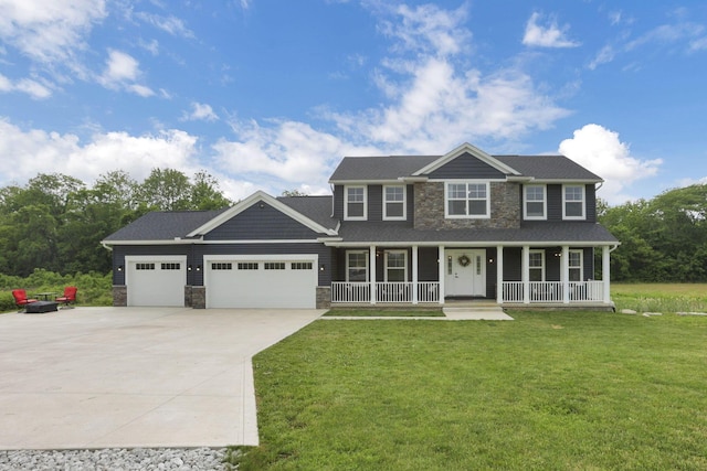 9559 Basil Rd NW, Baltimore, OH 43105 - view of front of house with covered porch, concrete driveway, an attached garage, and stone siding
