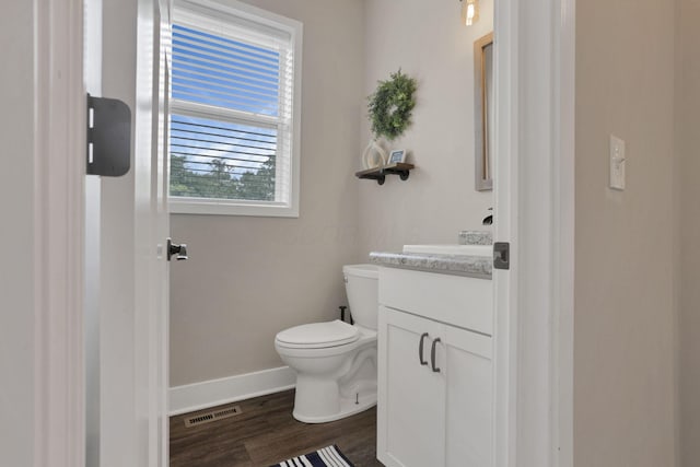 9559 Basil Rd NW, Baltimore, OH 43105 - bathroom featuring baseboards, vanity, toilet, and wood finished floors