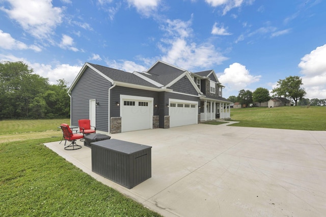 9559 Basil Rd NW, Baltimore, OH 43105 - view of home's exterior featuring concrete driveway, a lawn, stone siding, and a garage