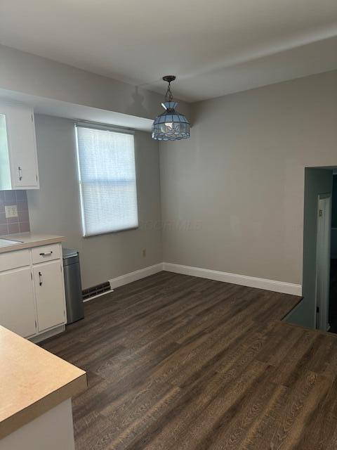 5800 Sandalwood Blvd, Columbus, OH 43229 - unfurnished dining area with dark wood-type flooring and baseboards