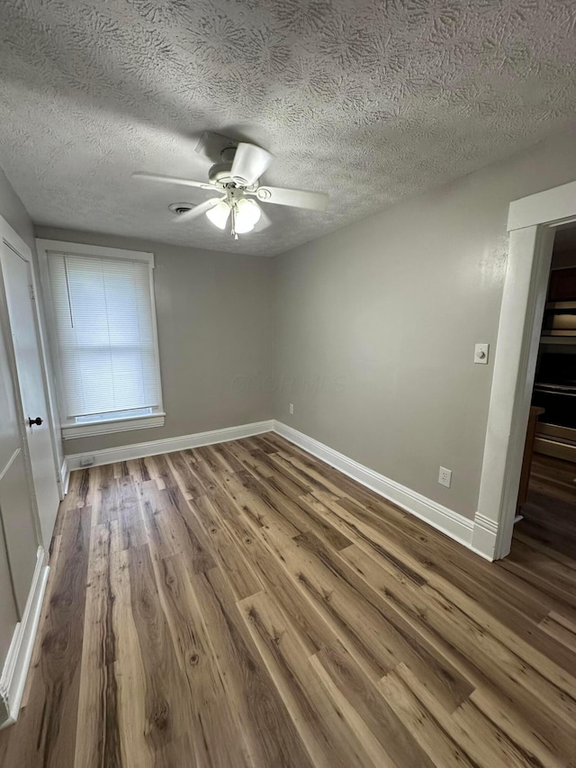 662 Frederick St, Lancaster, OH 43130 - unfurnished room with wood finished floors, baseboards, a ceiling fan, and a textured ceiling