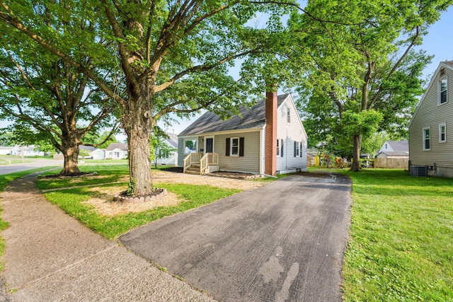 961 Davis Ave, Newark, OH 43055 - view of front of home with central AC unit, driveway, and a chimney
