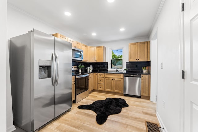 961 Davis Ave, Newark, OH 43055 - kitchen featuring appliances with stainless steel finishes, dark countertops, ornamental molding, a sink, and tasteful backsplash