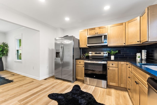 961 Davis Ave, Newark, OH 43055 - kitchen with appliances with stainless steel finishes, crown molding, dark countertops, light wood finished floors, and tasteful backsplash
