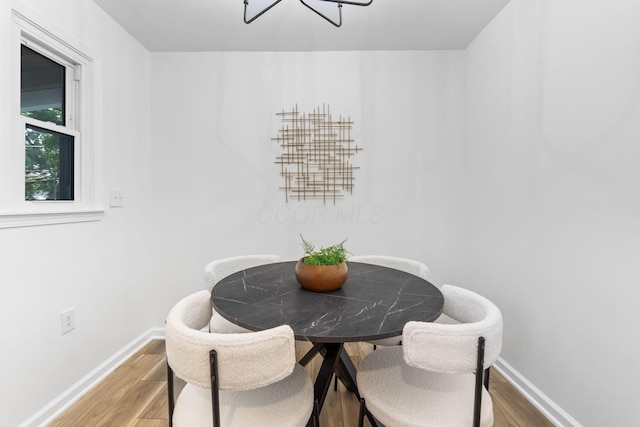 961 Davis Ave, Newark, OH 43055 - dining room featuring wood finished floors, baseboards, and a chandelier
