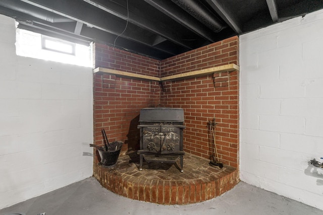 961 Davis Ave, Newark, OH 43055 - basement view of a wood stove, unfinished concrete flooring, and concrete block wall