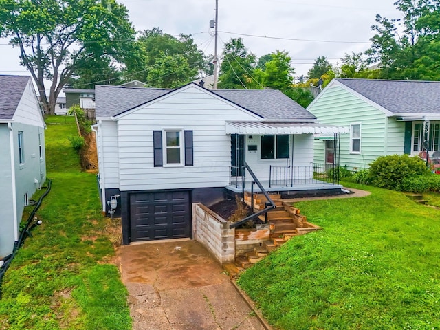 507 Brumfield Rd, Lancaster, OH 43130 - view of front of house featuring a garage, a shingled roof, driveway, and a front lawn