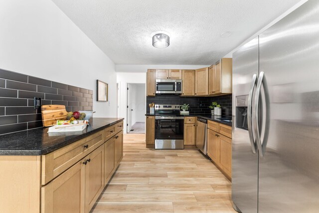507 Brumfield Rd, Lancaster, OH 43130 - kitchen featuring stainless steel appliances, tasteful backsplash, a textured ceiling, and light wood-style flooring
