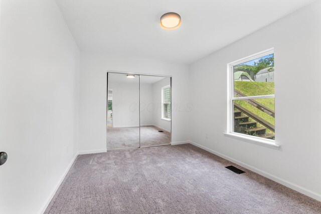 507 Brumfield Rd, Lancaster, OH 43130 - unfurnished bedroom featuring carpet floors, multiple windows, and baseboards