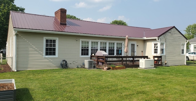 207 Newton Ave, Newark, OH 43055 - rear view of house with a chimney, a lawn, metal roof, and central air condition unit