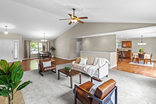 1245 Little Bear Loop, Lewis Center, OH 43035 - living area featuring a chandelier, lofted ceiling, a ceiling fan, light colored carpet, and baseboards