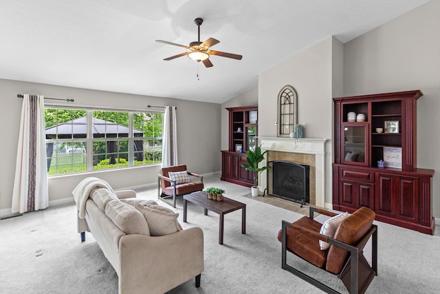 1245 Little Bear Loop, Lewis Center, OH 43035 - carpeted living room featuring a ceiling fan, vaulted ceiling, a tiled fireplace, and baseboards