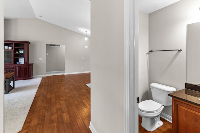 1245 Little Bear Loop, Lewis Center, OH 43035 - bathroom with vanity, toilet, lofted ceiling, wood finished floors, and baseboards