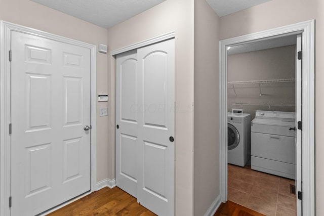 1245 Little Bear Loop, Lewis Center, OH 43035 - laundry area with separate washer and dryer, baseboards, and dark wood-style flooring