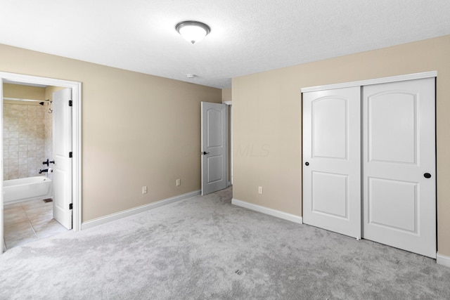 1245 Little Bear Loop, Lewis Center, OH 43035 - unfurnished bedroom with a closet, carpet floors, baseboards, and a textured ceiling