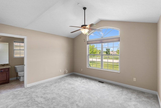 1245 Little Bear Loop, Lewis Center, OH 43035 - unfurnished bedroom with vaulted ceiling, light colored carpet, baseboards, ensuite bathroom, and a ceiling fan