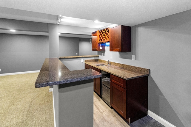 1245 Little Bear Loop, Lewis Center, OH 43035 - kitchen with a sink, dark countertops, baseboards, and a textured ceiling