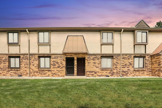 3195 Summerdale Ln, Columbus, OH 43221 - back of house with stucco siding, a lawn, and brick siding