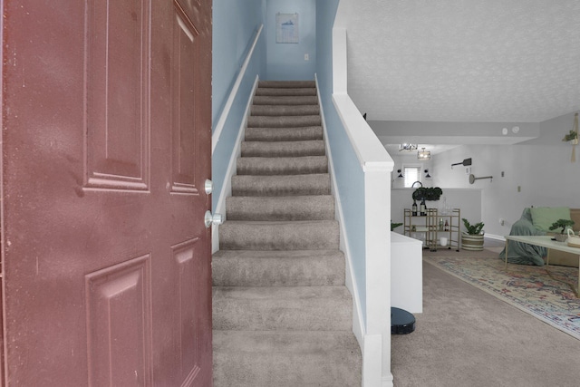 3195 Summerdale Ln, Columbus, OH 43221 - staircase with carpet flooring and a textured ceiling