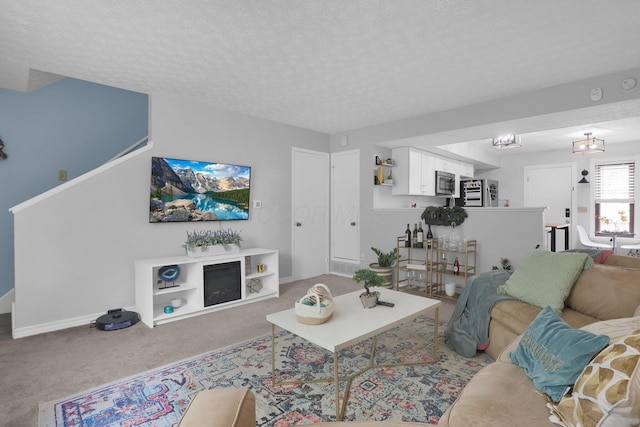 3195 Summerdale Ln, Columbus, OH 43221 - living room with carpet flooring, baseboards, and a textured ceiling