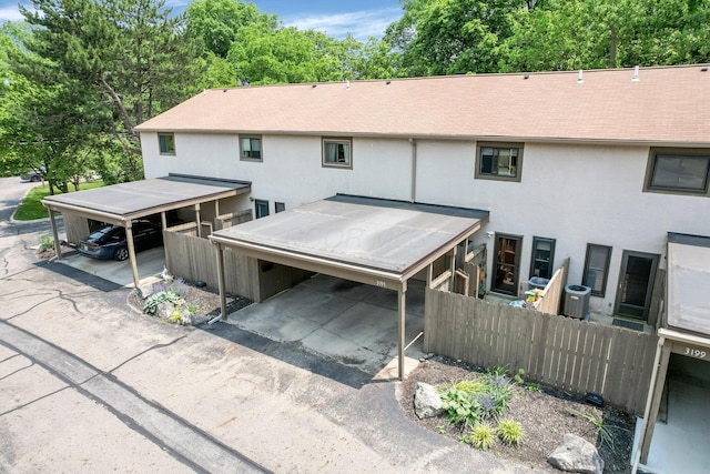 3195 Summerdale Ln, Columbus, OH 43221 - view of front facade featuring stucco siding, roof with shingles, and a carport