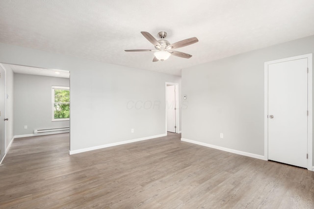133 Blendon Rd, West Jefferson, OH 43162 - empty room featuring a baseboard heating unit, a ceiling fan, wood finished floors, and baseboards
