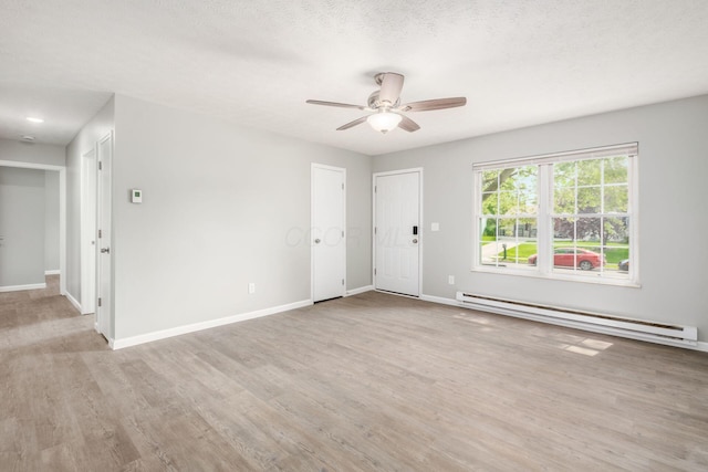 133 Blendon Rd, West Jefferson, OH 43162 - spare room with baseboard heating, wood finished floors, a ceiling fan, and baseboards