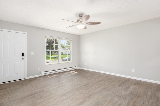 133 Blendon Rd, West Jefferson, OH 43162 - unfurnished room featuring a baseboard radiator, ceiling fan, wood finished floors, and baseboards