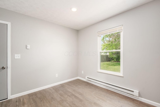 133 Blendon Rd, West Jefferson, OH 43162 - unfurnished room featuring a baseboard heating unit, wood finished floors, baseboards, and recessed lighting