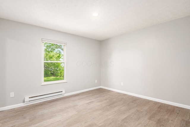 133 Blendon Rd, West Jefferson, OH 43162 - unfurnished room featuring baseboard heating, light wood-type flooring, and baseboards