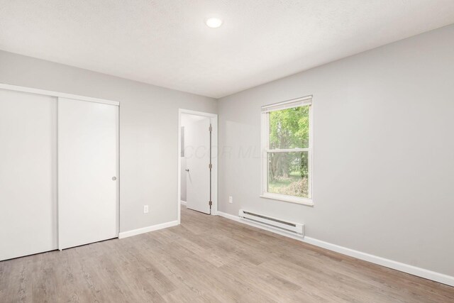 133 Blendon Rd, West Jefferson, OH 43162 - unfurnished bedroom featuring a baseboard heating unit, wood finished floors, baseboards, a closet, and recessed lighting