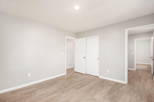 133 Blendon Rd, West Jefferson, OH 43162 - unfurnished bedroom featuring light wood finished floors, baseboards, and a closet
