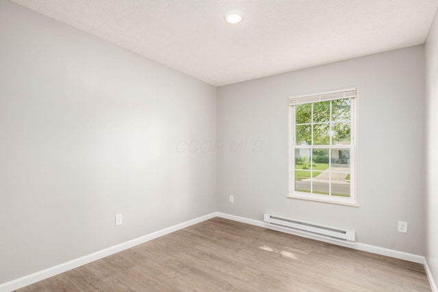 133 Blendon Rd, West Jefferson, OH 43162 - unfurnished room with a baseboard radiator, baseboards, and wood finished floors