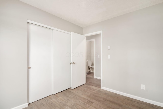 133 Blendon Rd, West Jefferson, OH 43162 - unfurnished bedroom featuring light wood-type flooring, baseboards, and a closet