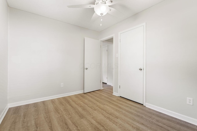 895 Caniff Rd, Columbus, OH 43221 - unfurnished bedroom featuring wood finished floors, baseboards, and a ceiling fan