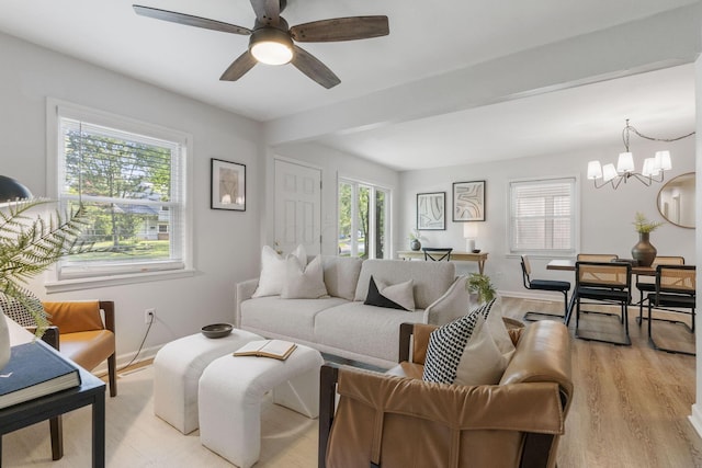 895 Caniff Rd, Columbus, OH 43221 - living area with light wood-style flooring, a chandelier, baseboards, and a ceiling fan
