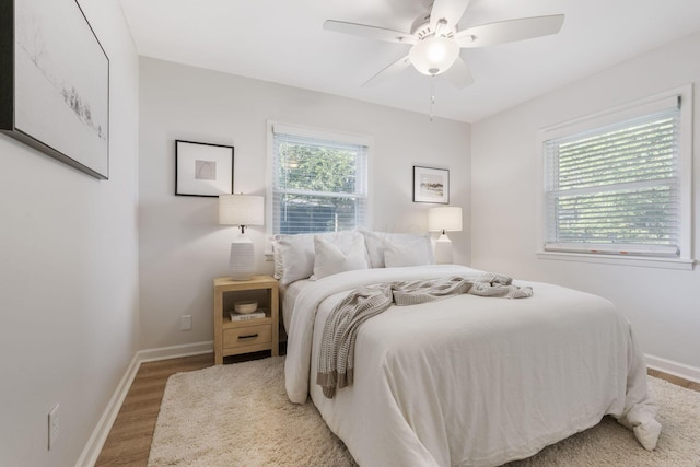 895 Caniff Rd, Columbus, OH 43221 - bedroom featuring baseboards, wood finished floors, and a ceiling fan