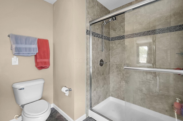 1598 Metcalfe Ave, Obetz, OH 43207 - bathroom featuring baseboards, a stall shower, and toilet