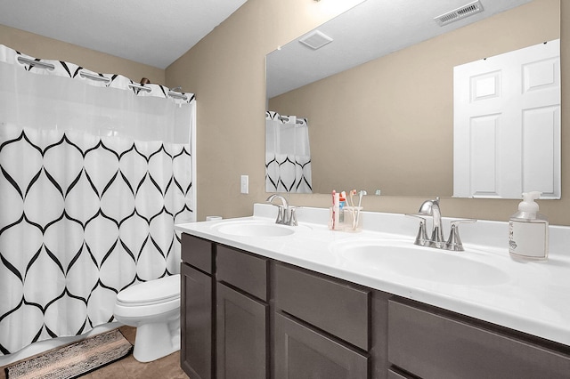 1598 Metcalfe Ave, Obetz, OH 43207 - bathroom with double vanity, tile patterned flooring, toilet, and curtained shower