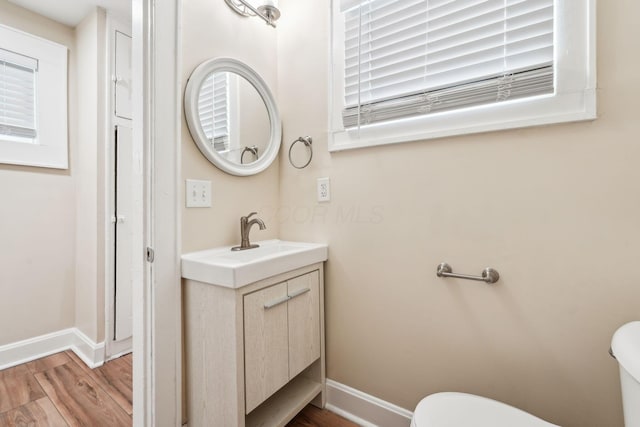 943 S Champion Ave, Columbus, OH 43206 - half bath with toilet, wood finished floors, vanity, and baseboards
