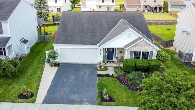 91 Richard Ave, South Bloomfield, OH 43103 - ranch-style home with driveway, a garage, roof with shingles, and a residential view