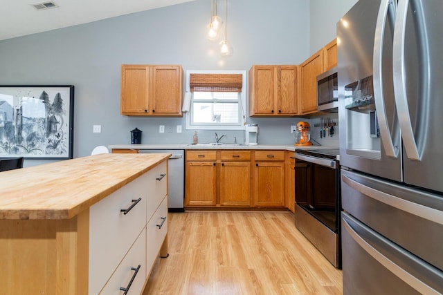 91 Richard Ave, South Bloomfield, OH 43103 - kitchen with stainless steel appliances, wood counters, light wood-style flooring, a sink, and pendant lighting