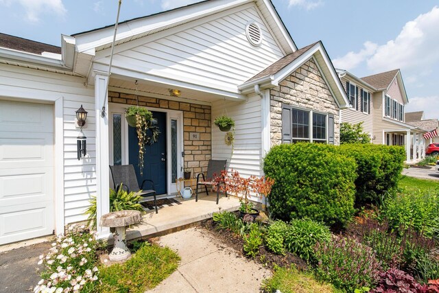 91 Richard Ave, South Bloomfield, OH 43103 - entrance to property with stone siding, a porch, and roof with shingles
