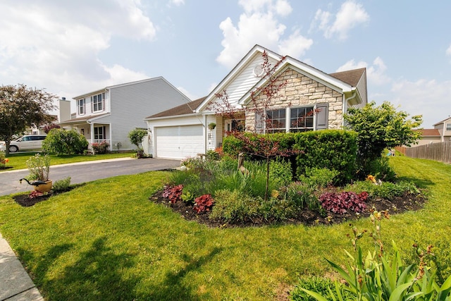 91 Richard Ave, South Bloomfield, OH 43103 - view of front of home featuring stone siding, driveway, and an attached garage