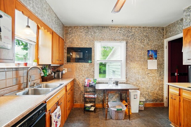 2506 Chester Rd, Columbus, OH 43231 - kitchen with a sink, black appliances, light countertops, and baseboards