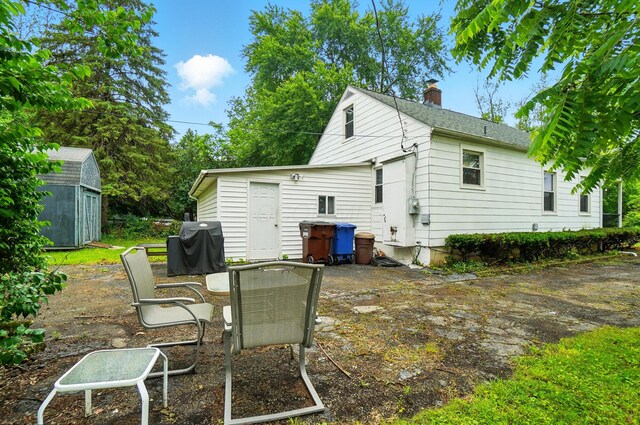 2506 Chester Rd, Columbus, OH 43231 - rear view of house featuring a chimney and a patio